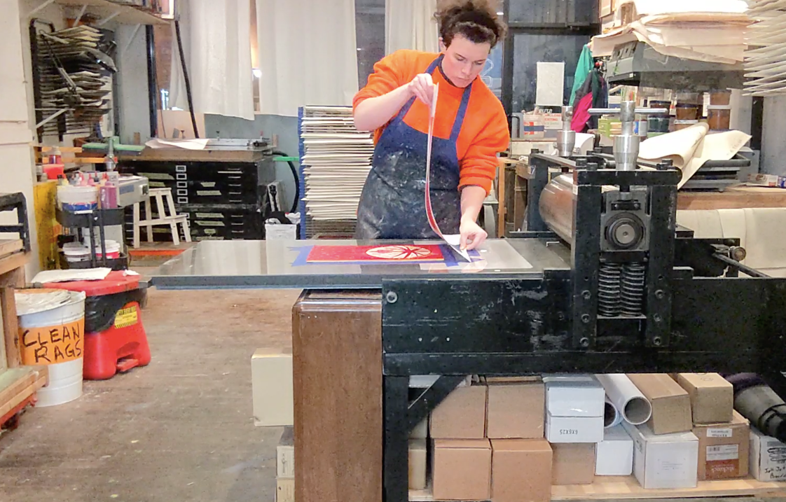 Load video: Hand printing the second color of a woodblock at the Shoestring Press in Brooklyn, NY
